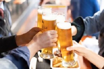 大きなビールジョッキを片手に、乾杯をしている人たち