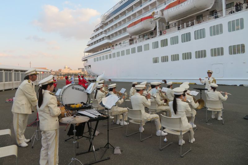 船内のお客さんに向けて演奏と演技を行う福岡市消防音楽隊の写真