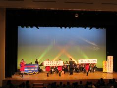 演奏中にクイズを出題する福岡市消防カラーガード隊の写真
