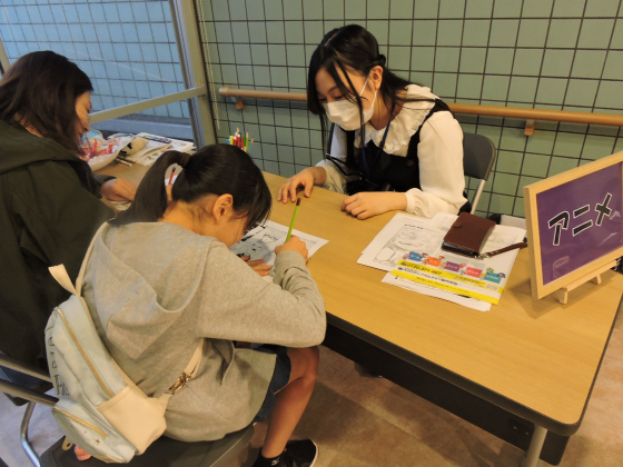 子どもがイラスト体験で絵を描いている写真