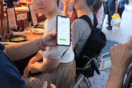 屋台での使用例、画面を見せている