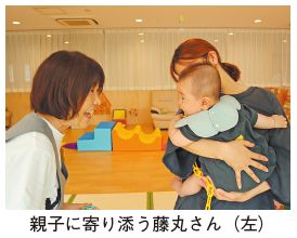 親子に寄り添う藤丸さん（左）の写真